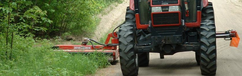 Photo of tractor doing roadside mowing.